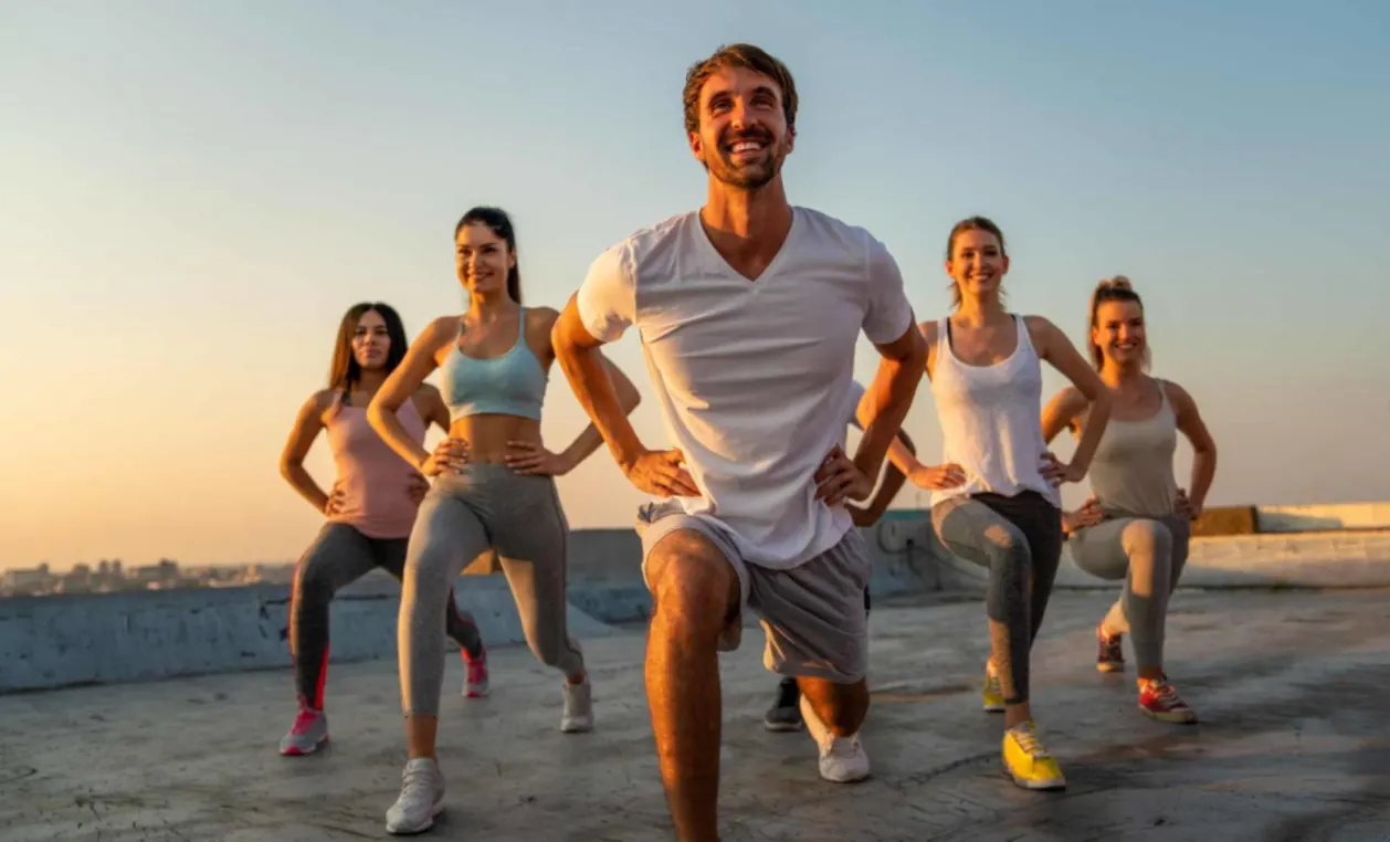 Group of happy fit people friends exercising on a fitcation
